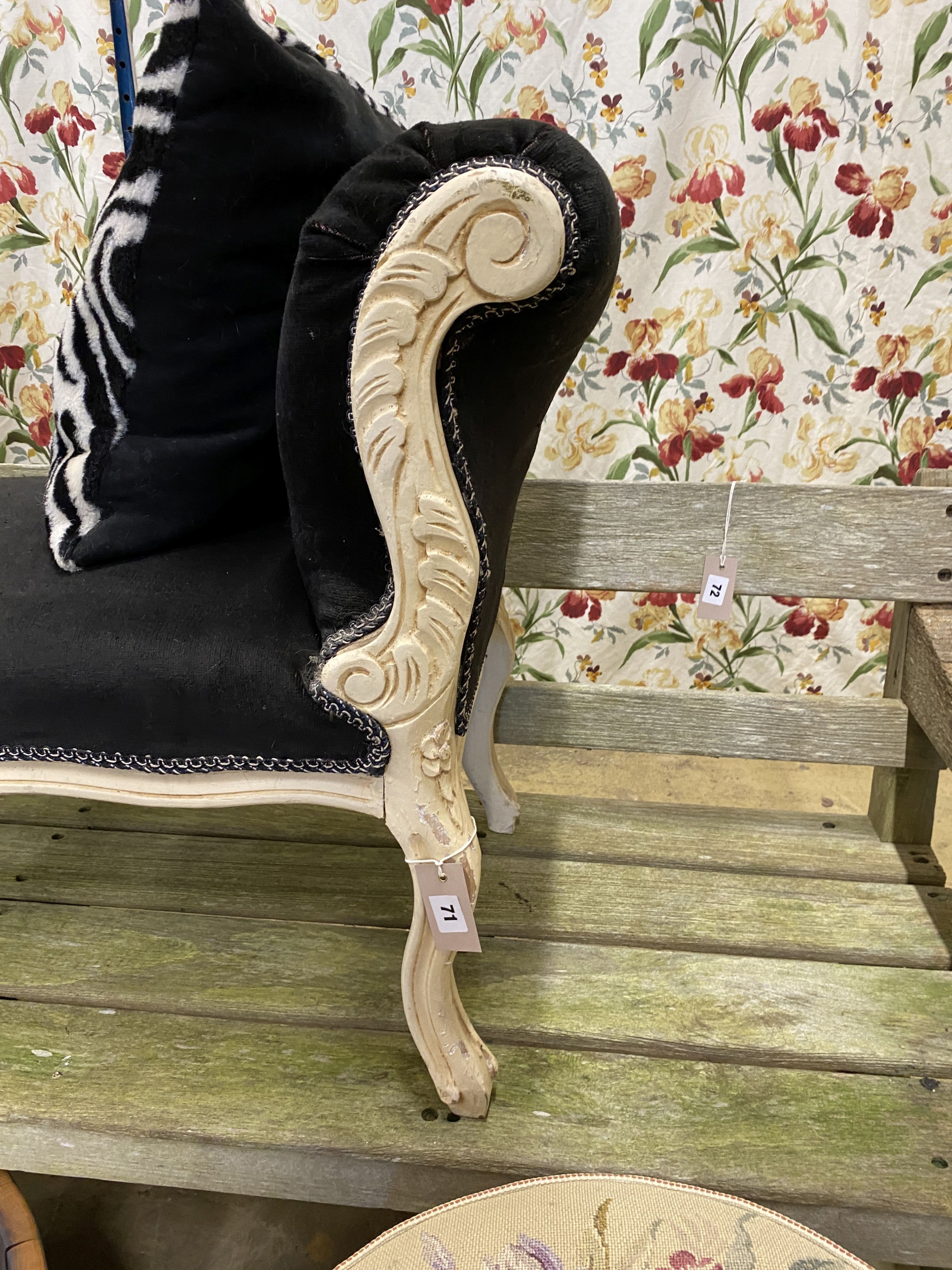 A rococo style painted scroll end window seat, length 110cm, depth 46cm, height 70cm and a footrest